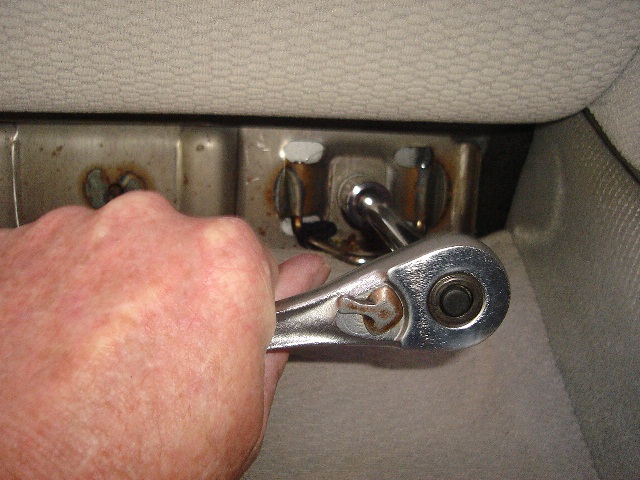 Remove lower seat cushion bolts