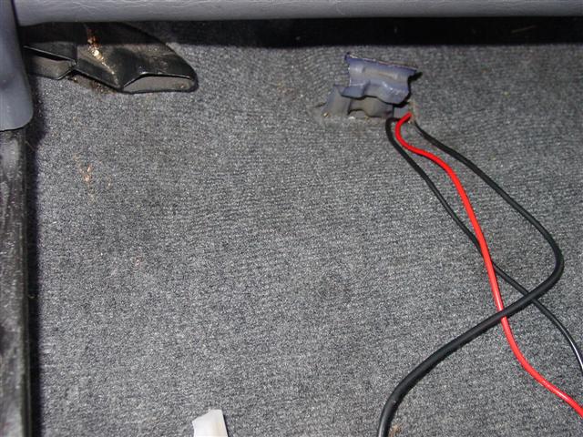 Radio wiring poking out of carpet